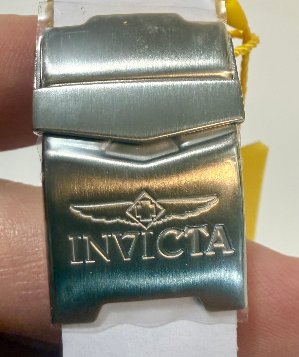 Silver Invicta buckle on a wrist with a white background