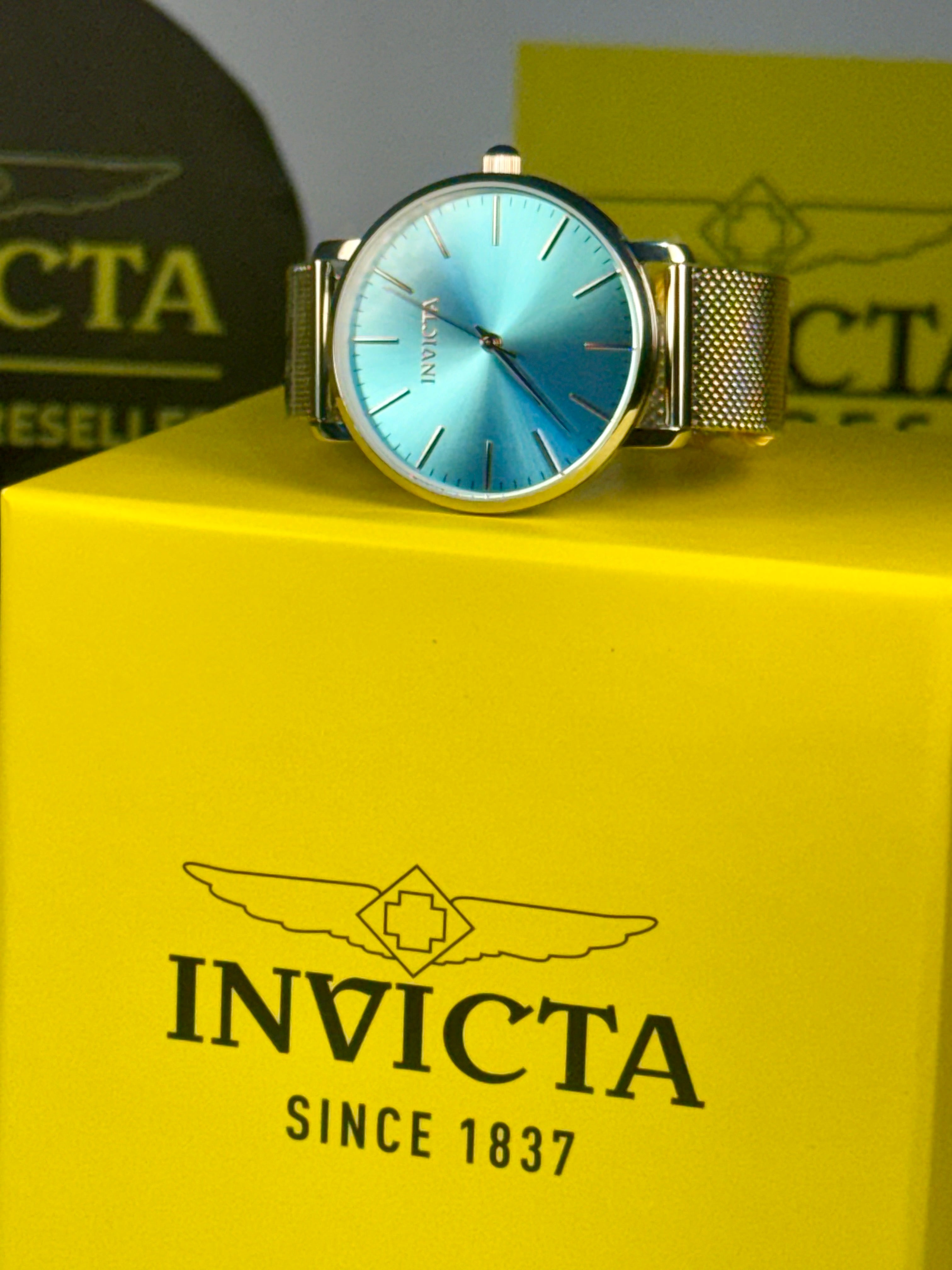 Invicta Angel Starlight   watch on a yellow box with brand logo
