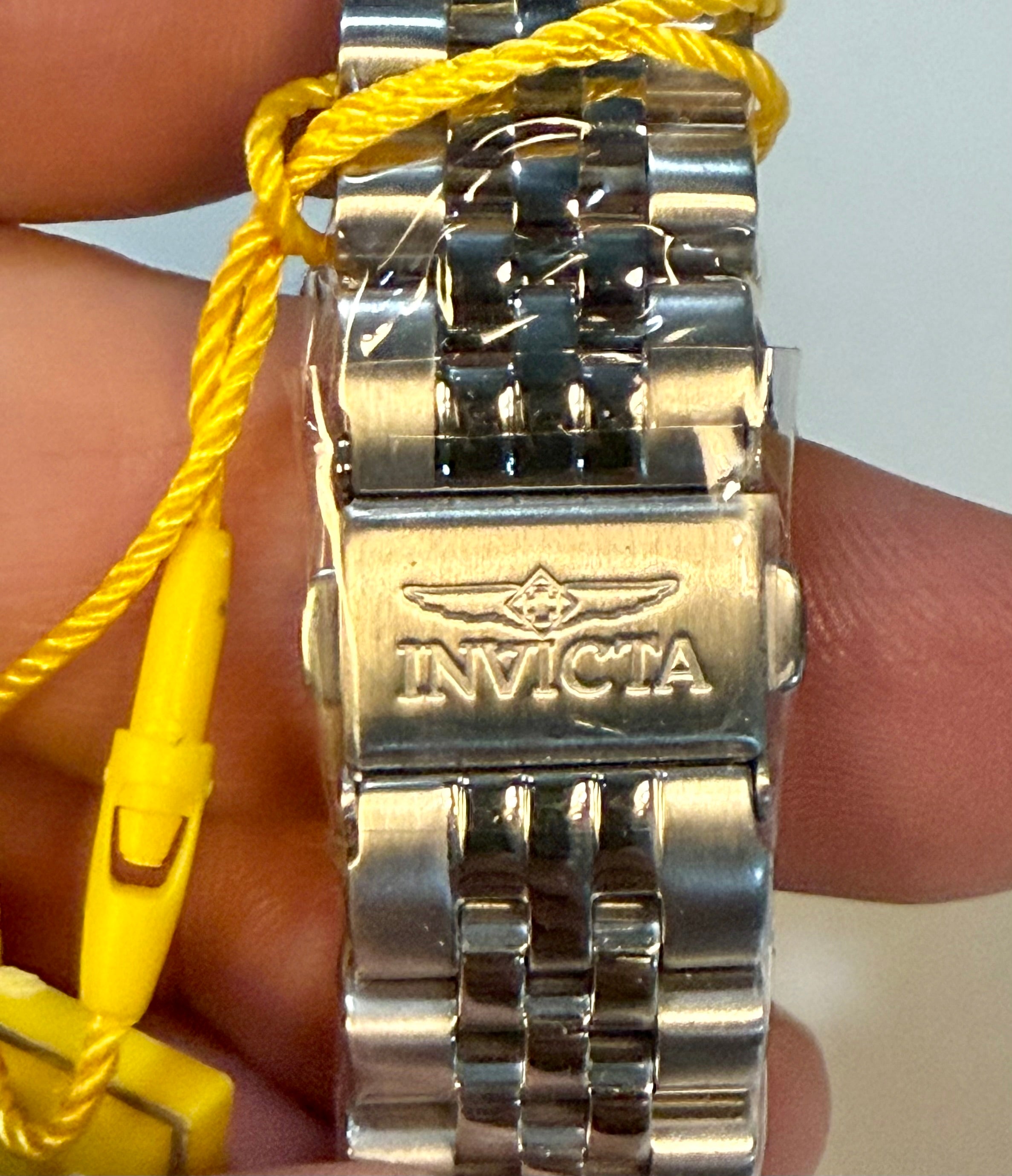 SilverInvicta Ladies Specialty 36mm  watch with a yellow cord on a person's wrist