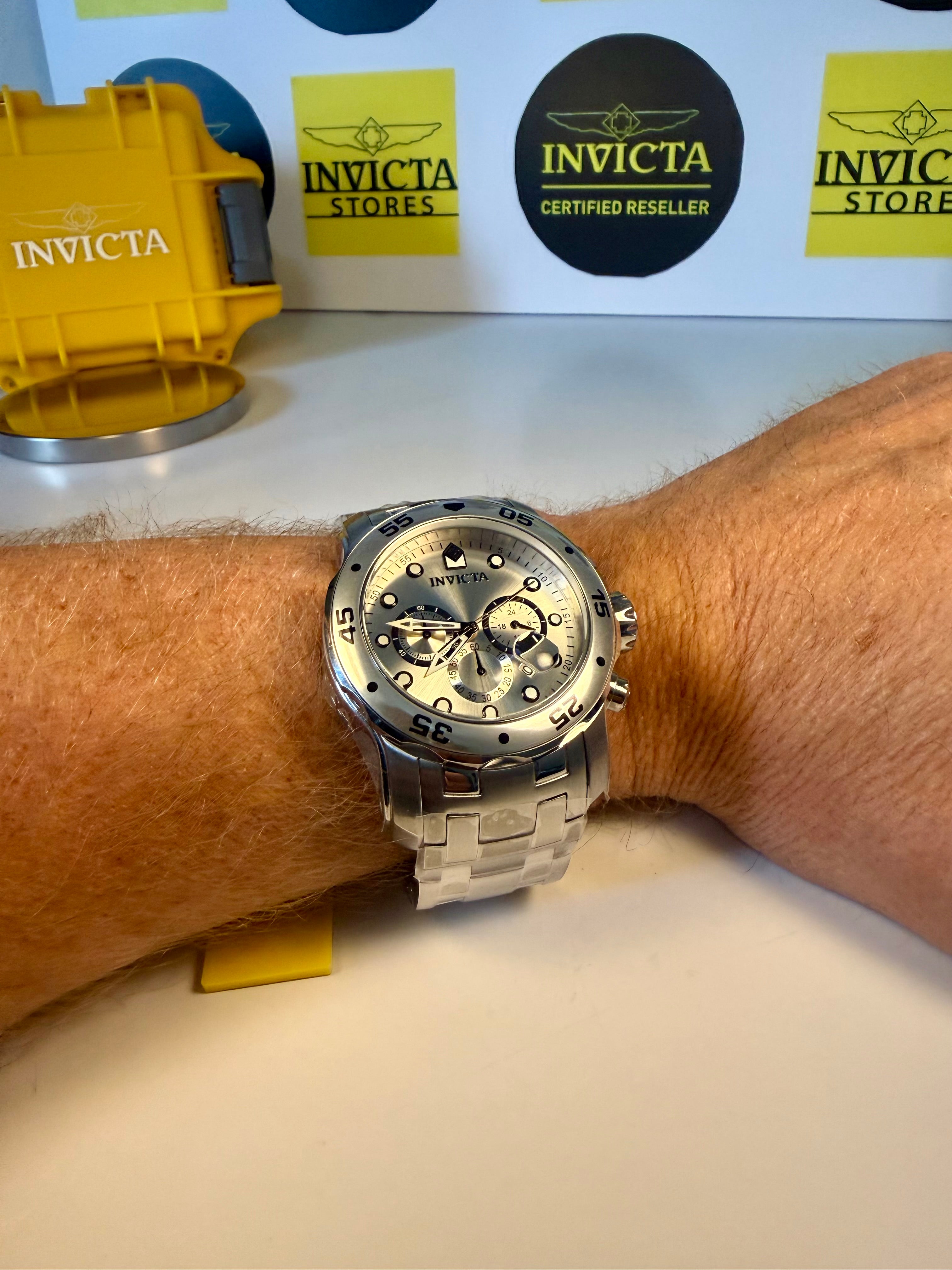 Invicta Pro Diver Scuba 48mmwatch on a wrist with brand logos in the background