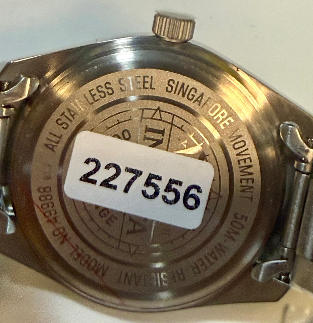 Close-up of a Invicta Ocean Voyage 41mm  with engraving and a visible serial number on a white background