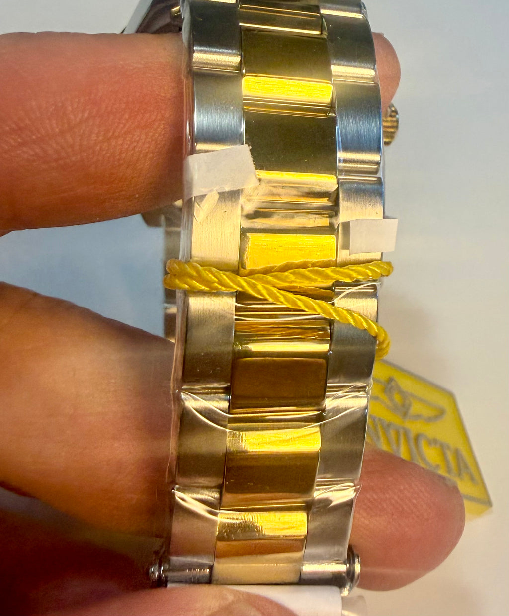 nvicta Speedway Monte Carlo watch with a yellow strap on a person's wrist, brand tag visible.