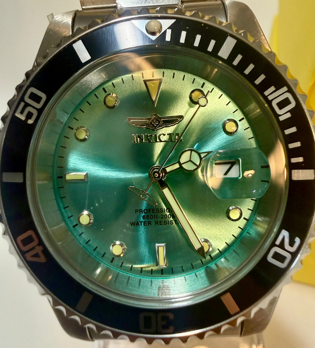 Invicta Pro Diver 47356 Men 40mm Quartz Turquoise Blue Dial Steel Sport Watchand silver case on a white background