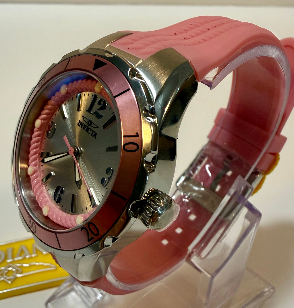 Pink watch with a clear stand on a white background