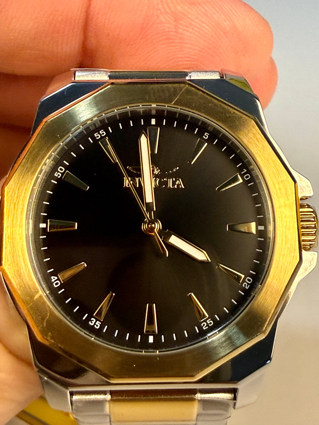 Speedway Ladies 34mm Combo Gold and silver watch with black face held by a hand
