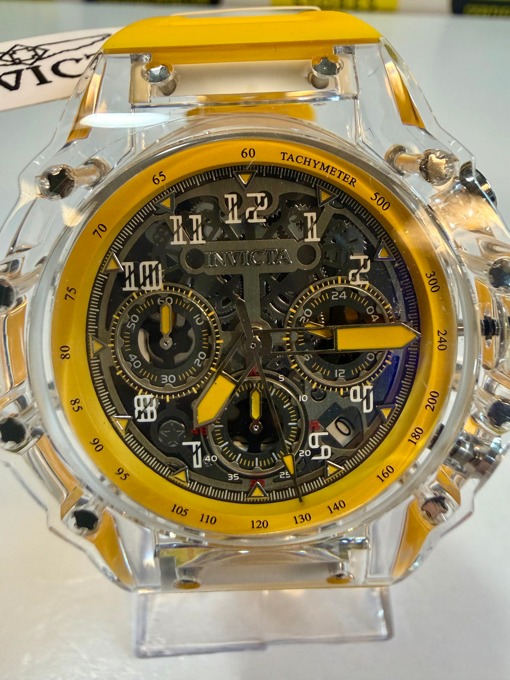 Invicta Racing Vaulthan 44mm Luxury watch with transparent case and yellow accents on a white background