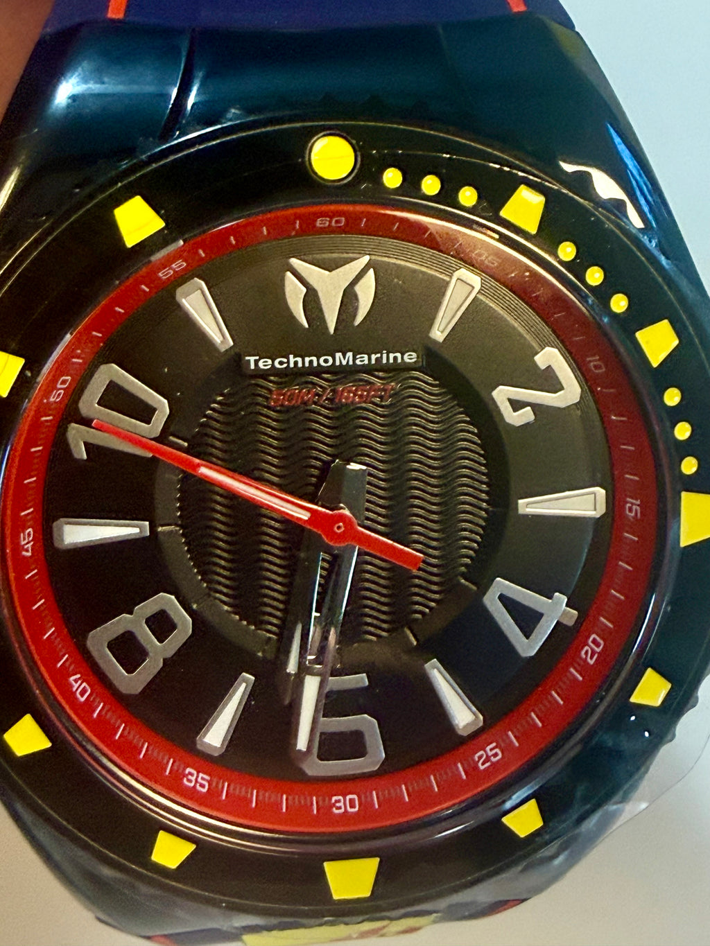 Techno Marine Racing Legends Wristwatch  with a black face, red accents, and yellow accents on a blue strap.