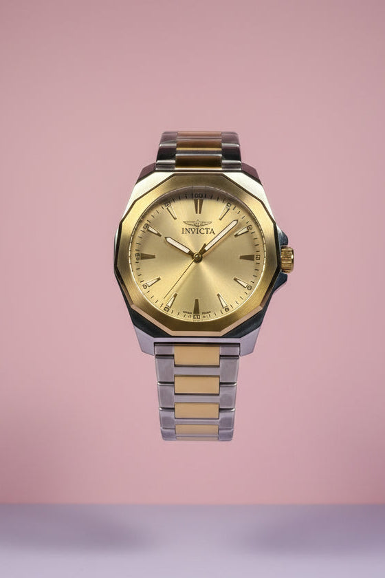 Invicta Speedway Gold and silver watch on a gradient pink and gray background