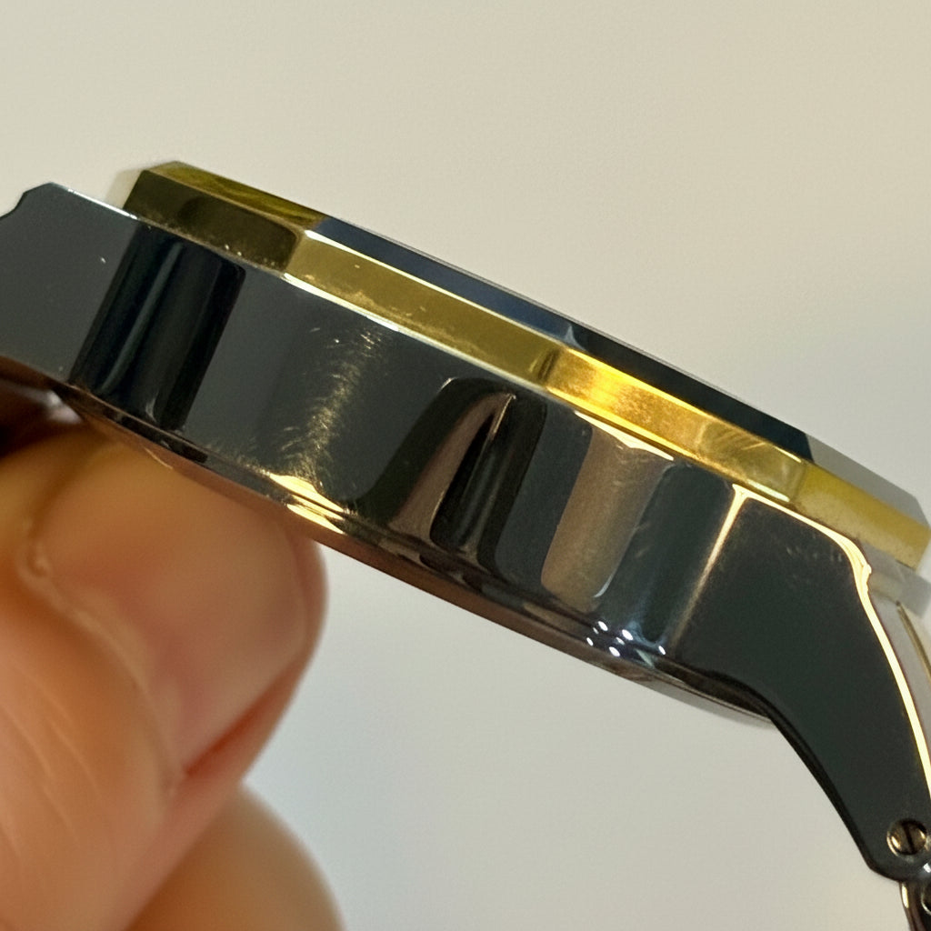 Close-up of a Mens 42mm Invicta Speedway Dominusband being held with a plain background
