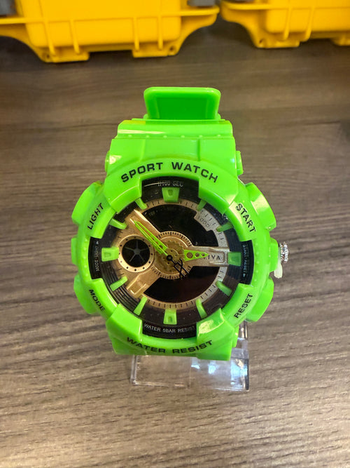 Activa Green sports watch with black and gold details on a wooden surface