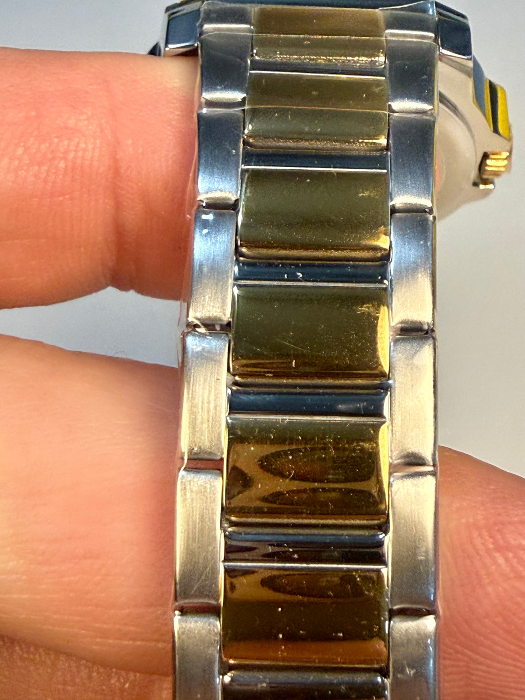 Close-up of Speedway Ladies 34mm Combo a silver and gold watch band on a wrist.