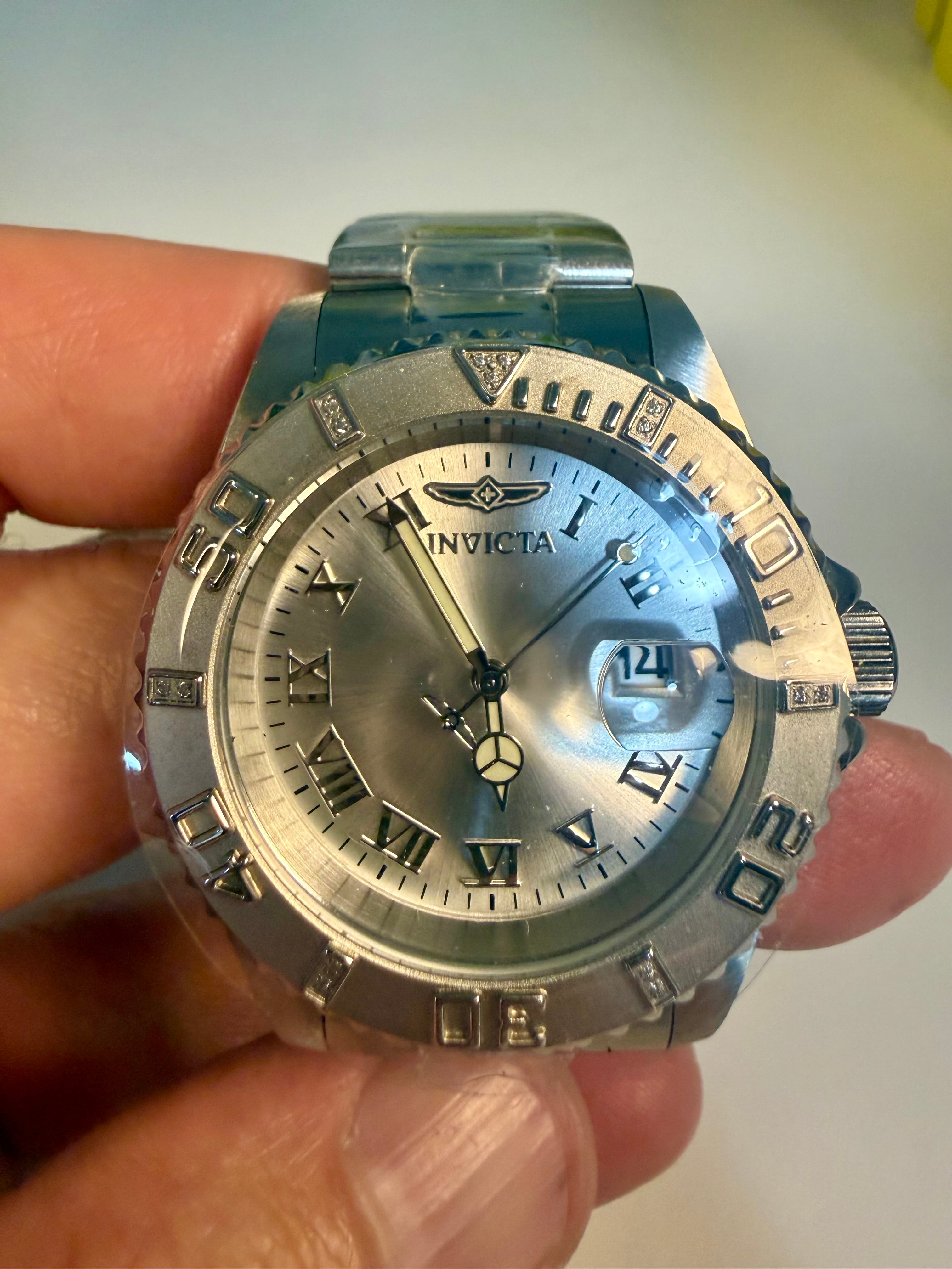 Invicta Pro Diver 12819 Swiss Ronda 515 40mm 0.06ctw Diamond Silver Invicta watch held in a hand with a plain background