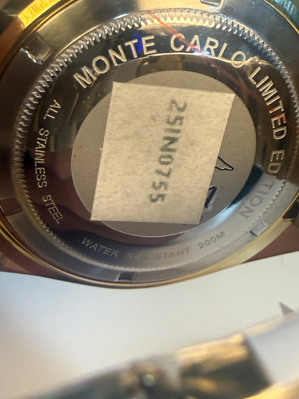 Invicta Speedway Monte Carlo Gold Close-up of a watch case with 'Monte Carlo Limited Edition' text and serial number.