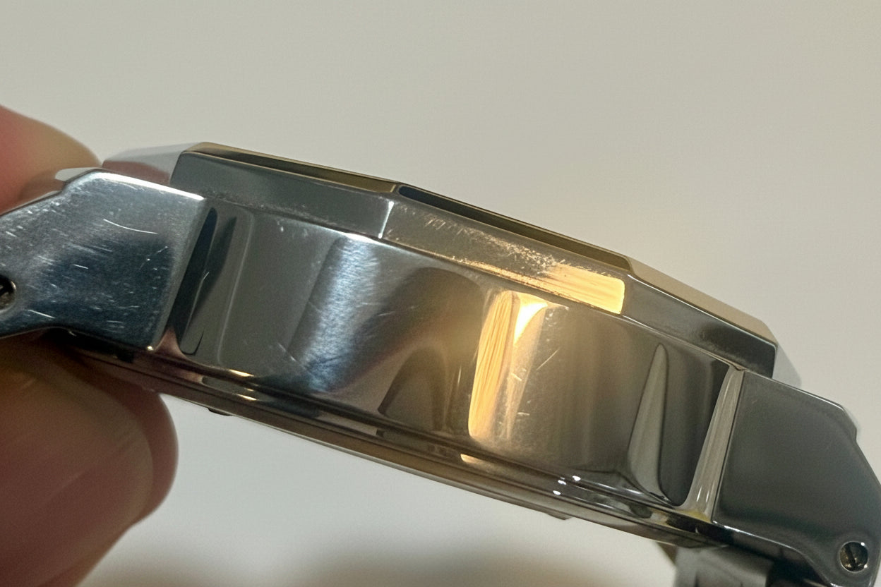Close-up of a Invicta Speedway 42mm Mens Watch band held by a hand against a white background