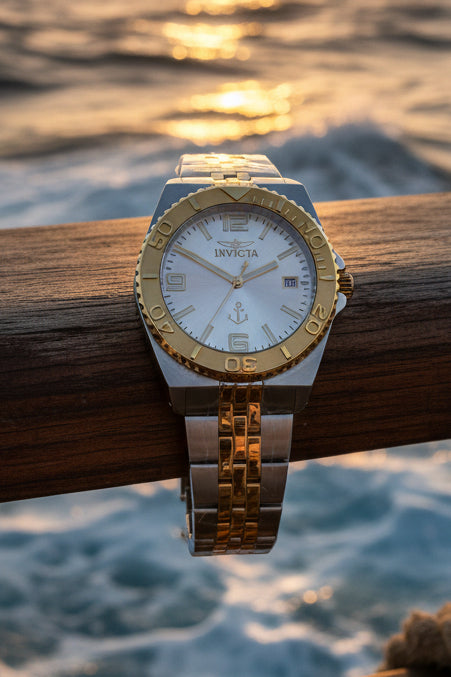 Invicta Ocean Voyage 38mm Pro Diver Silver and gold watch on a white surface with Invicta packaging in the background.