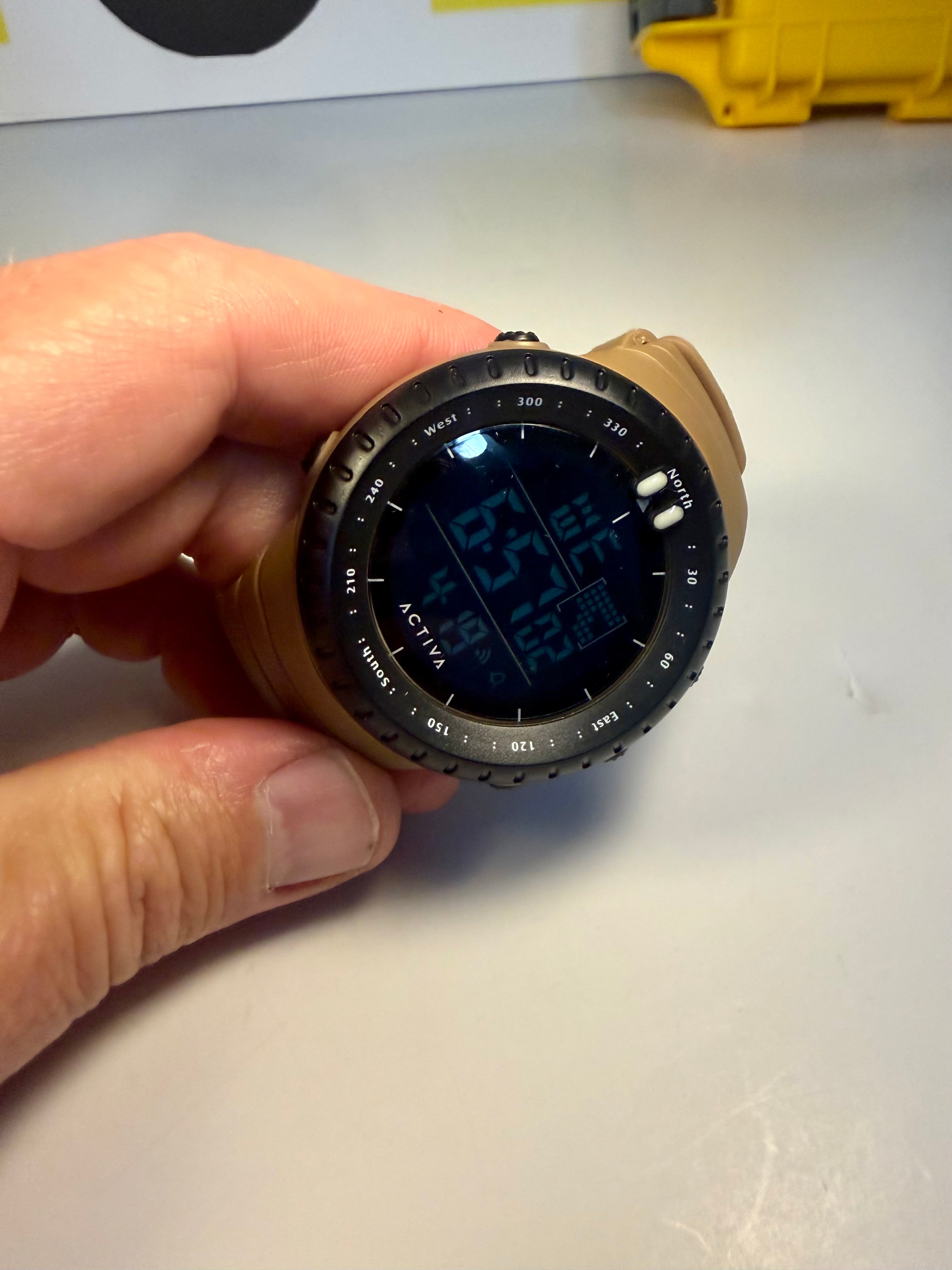 Activa X Odyssey Digital watch held in a hand on a light background
