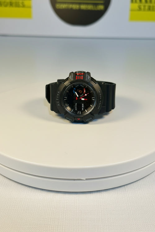Black wristwatch on a white circular platform with a blurred background