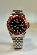 Invicta Mens Pro Diver 43mm Heritage watch with red and black bezel on a light gray background