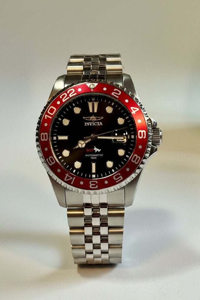 Invicta Mens Pro Diver 43mm Heritage watch with red and black bezel on a light gray background
