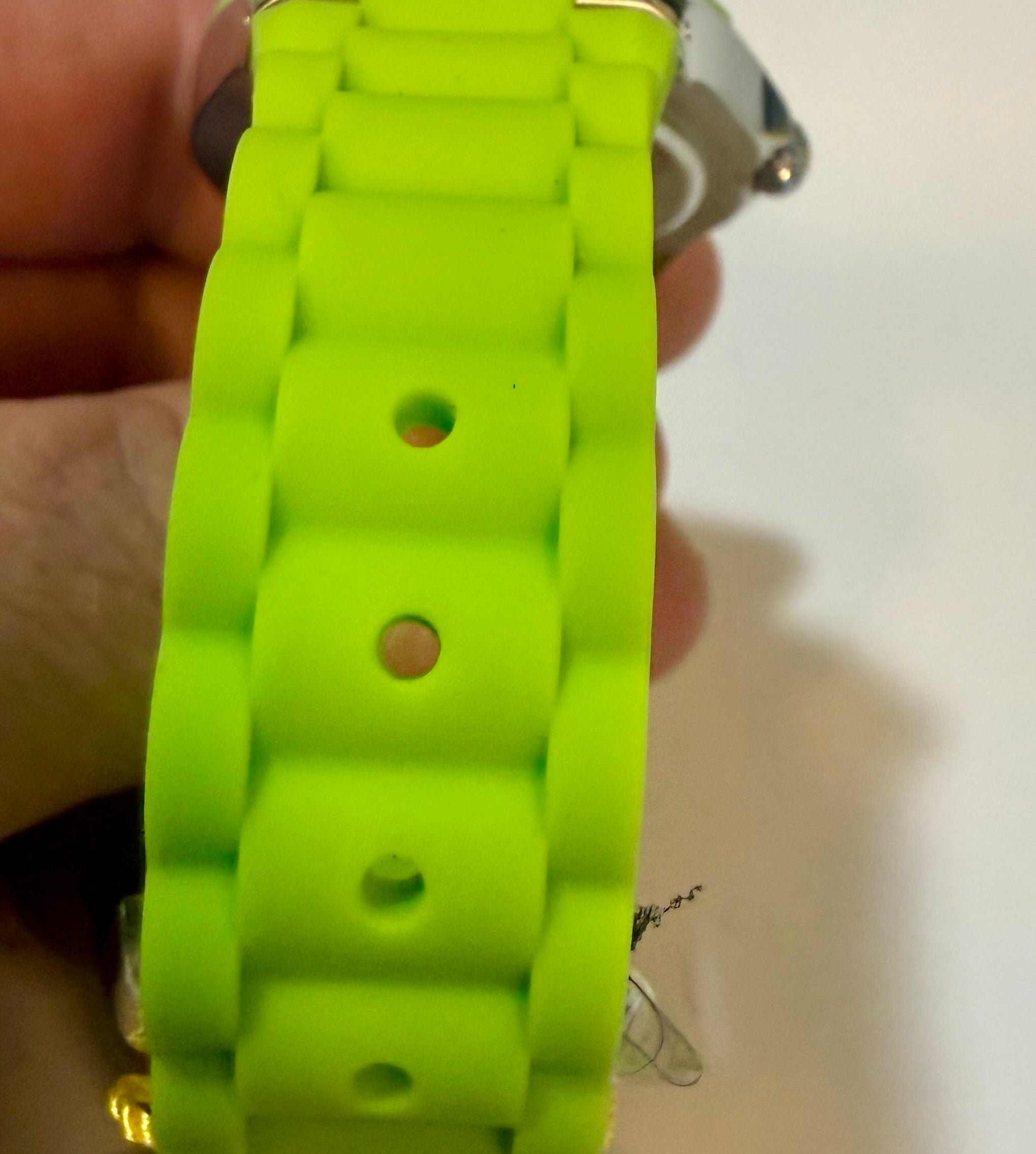 Close-up of aInvicta Unisex 38mm Angel  strap held by a person's hand.