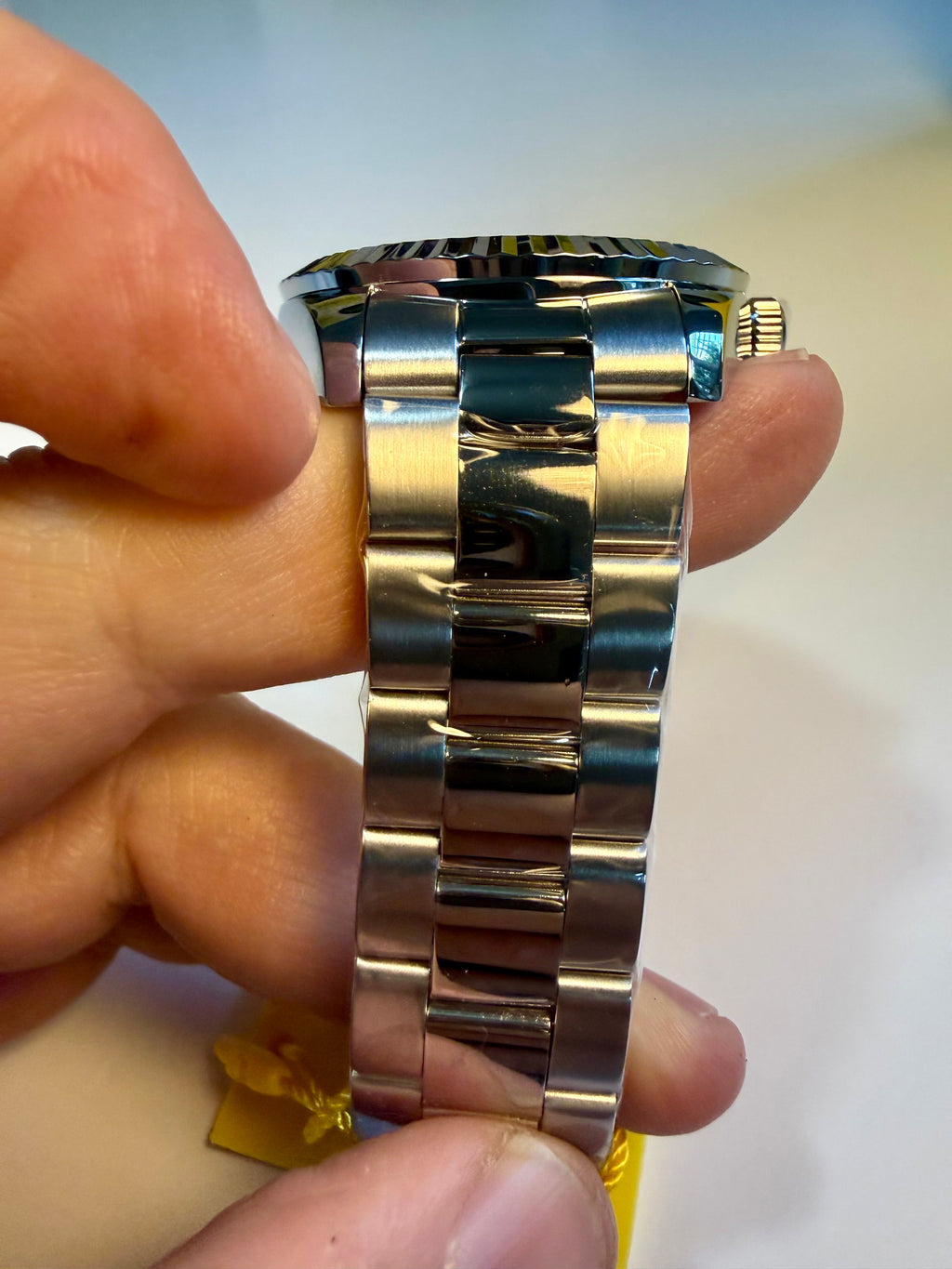 Invicta Specialty Stratford watch band held by a hand with a blurred background