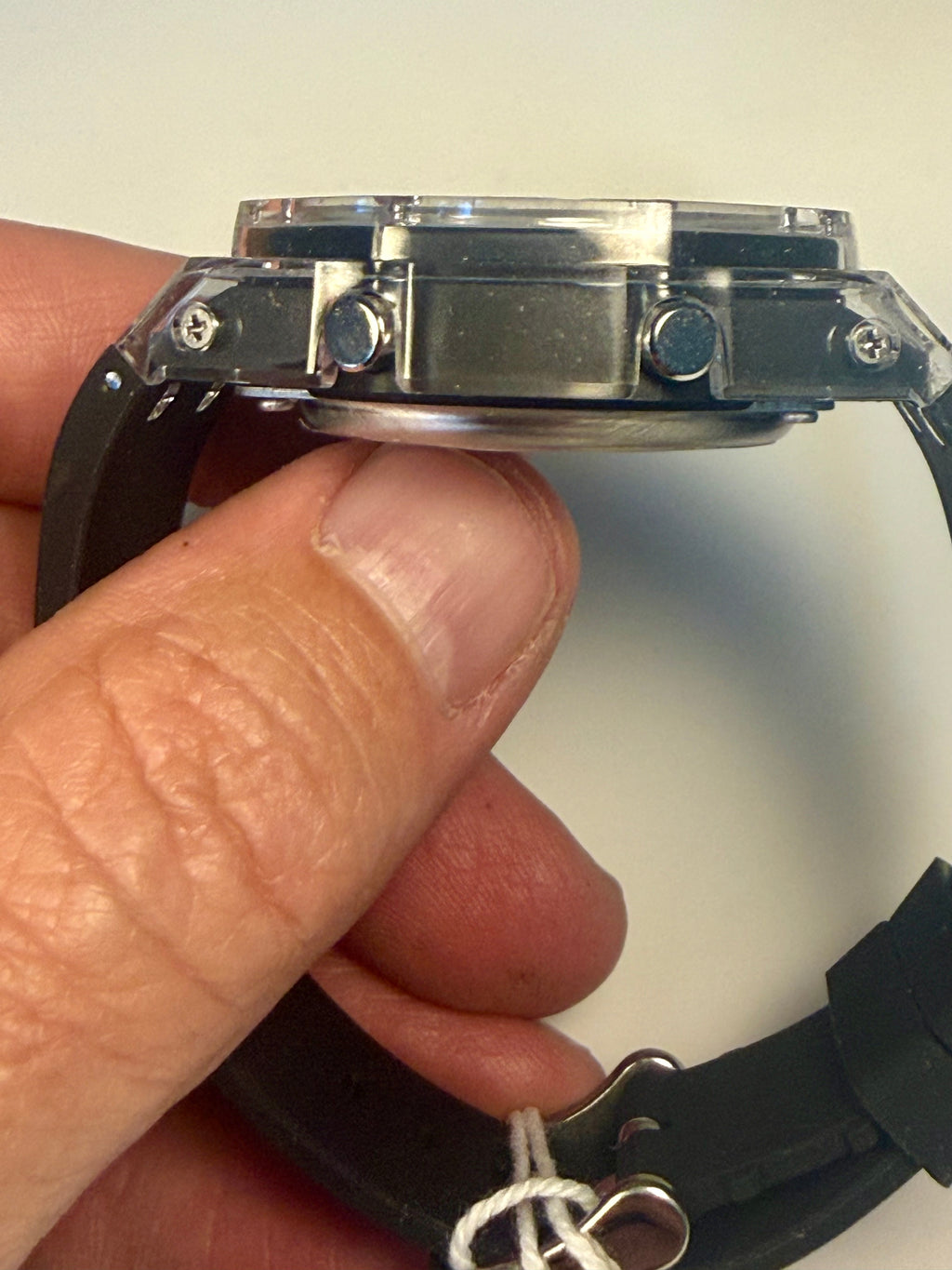 Close-up of a person holding aActiva Kaleido Rainbow  watch with a white background