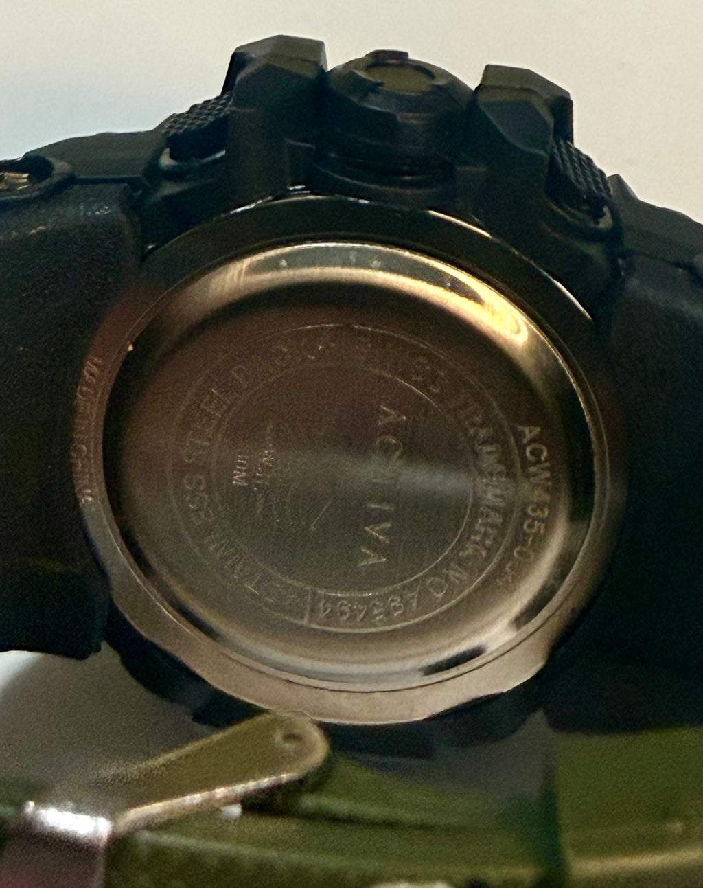 Close-up of a Activa Tactical Xwatch with a visible brand logo on a reflective surface