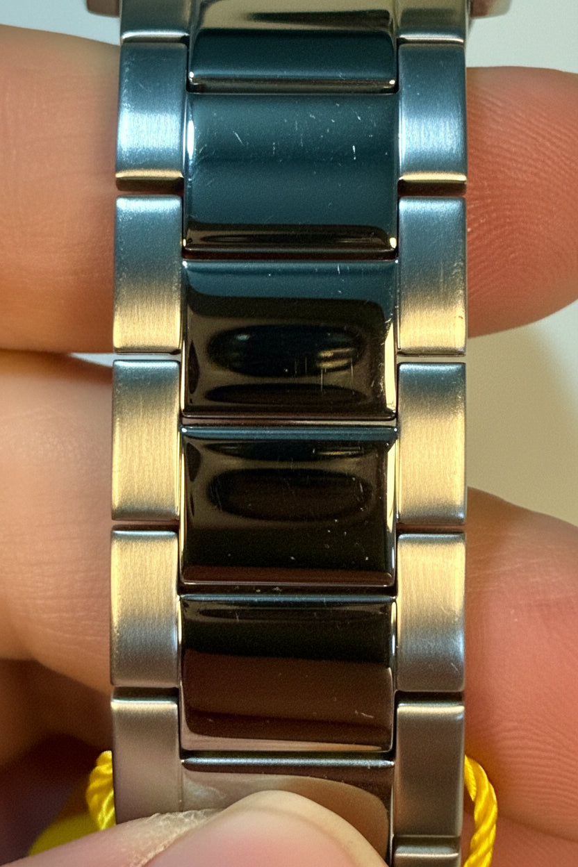 Close-up of a Invicta Specialty Gramercy 45mm Mens silver watch band on a wrist