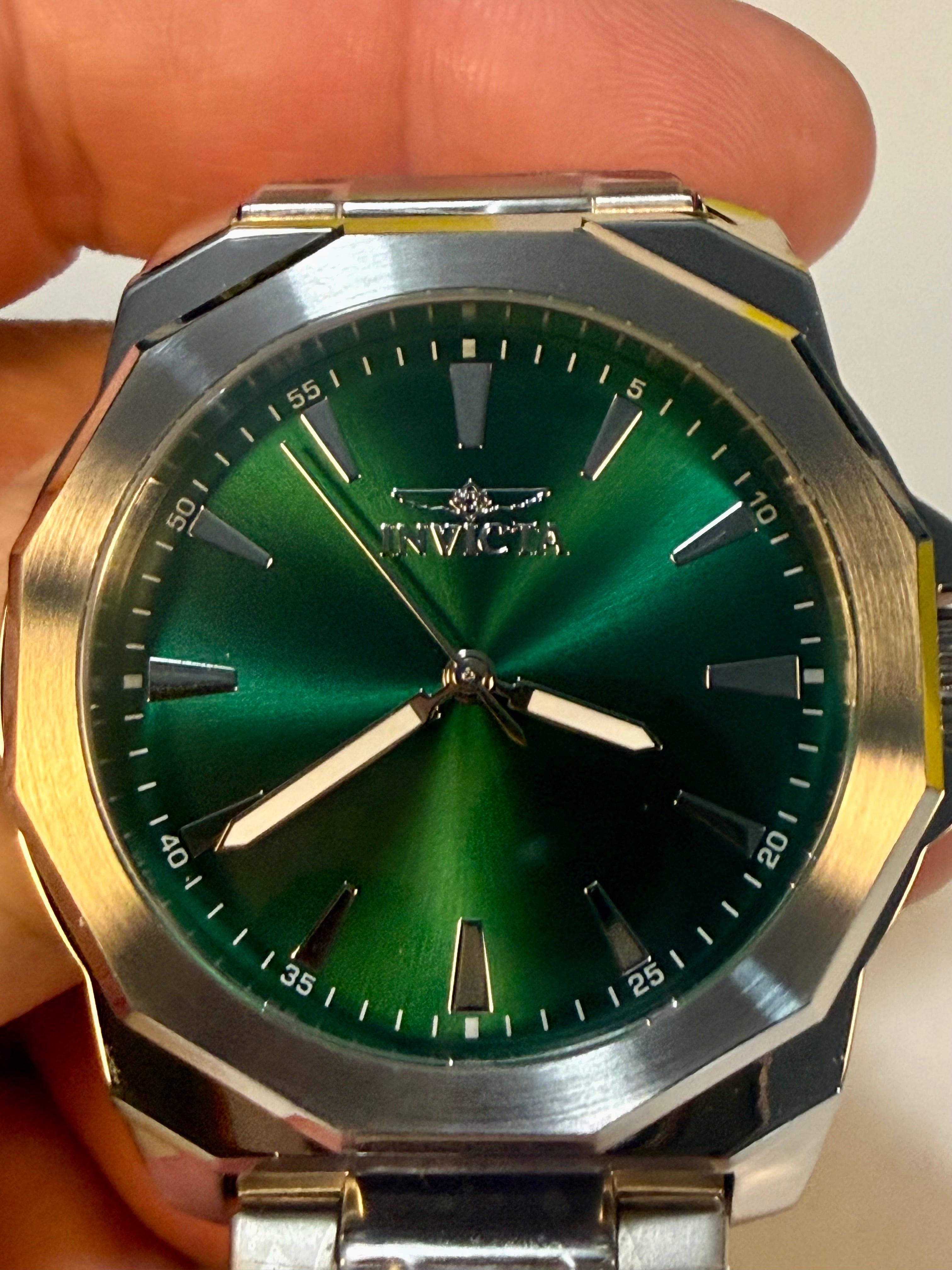 Mens 42mm Invicta Speedway Dominus Green watch with gold and silver accents held by a hand