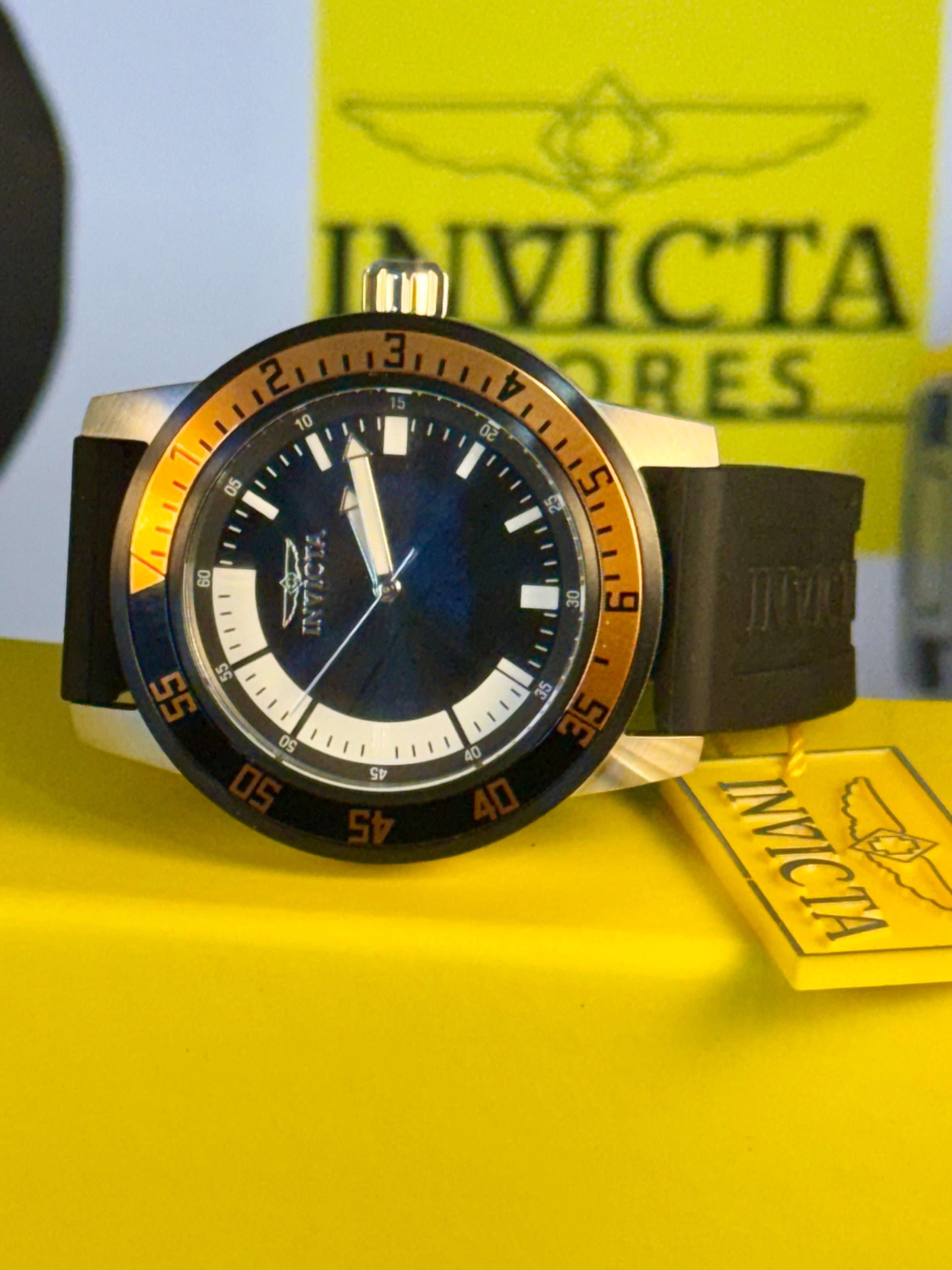 Invicta Specialty Compass in Bronze  in Bronze watch with a yellow background featuring the brand logo.