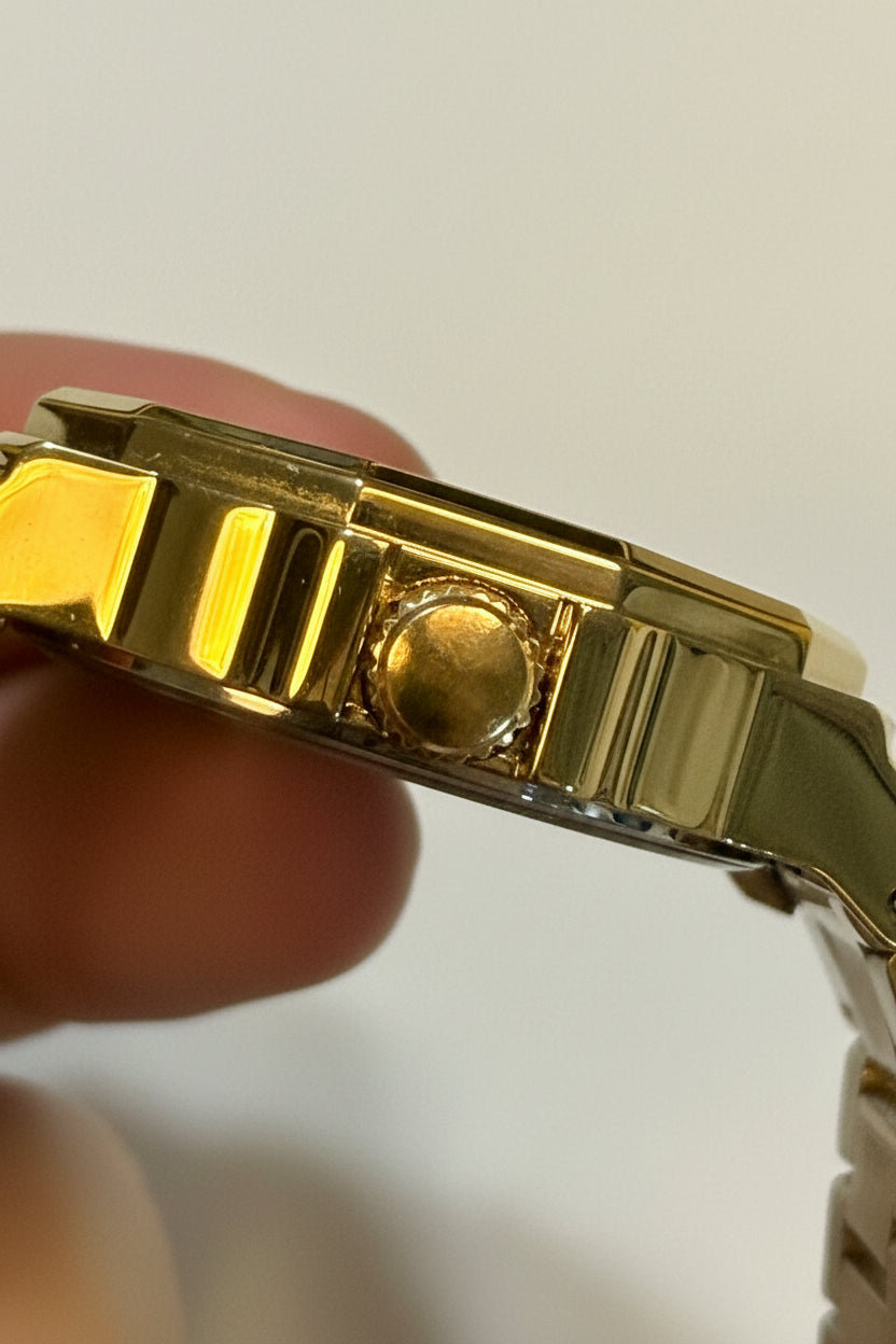 Invicta Speedway 46840 Gold Dial Gold Plated Steel 42mm Quartz Men's Watch held by a hand against a white background