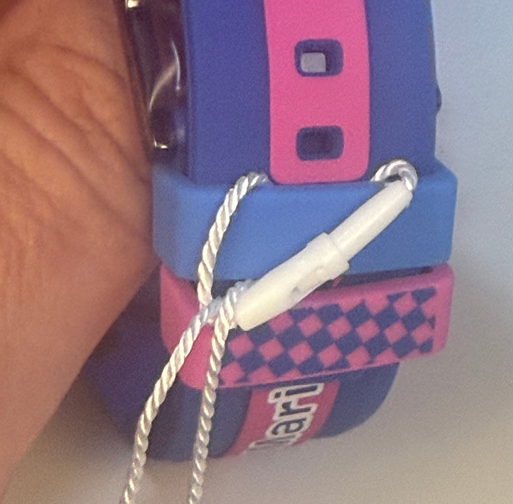 Close-up of a Techno Marine Racing Legends 44mm Wristwatch  blue and pink device with a white cord, possibly a toy or gadget, on a light background.