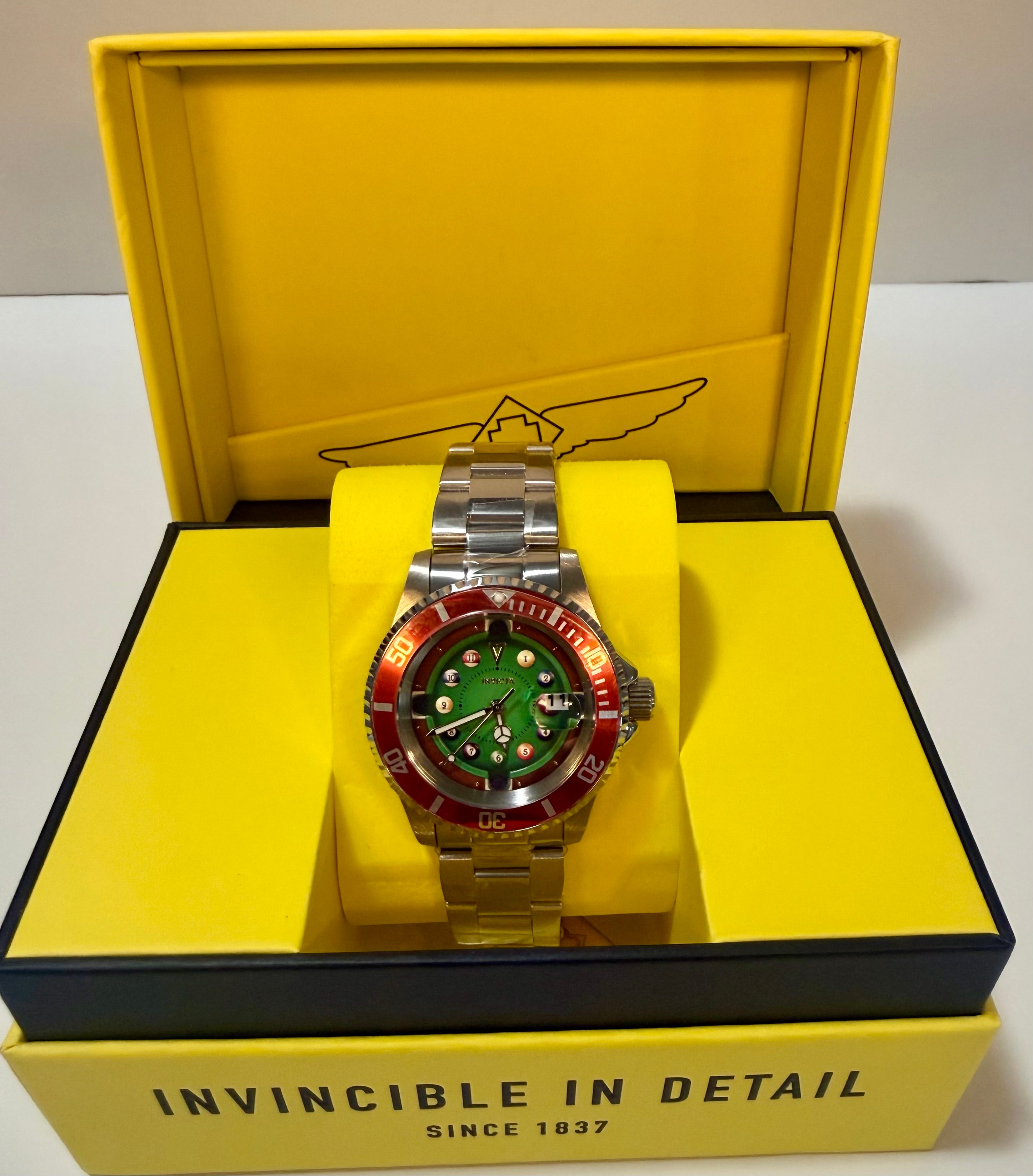 WatInvicta Pro Diver House of Cards Men's Watch - 40mm.ch with green face and red accents on a yellow box with 'Invincible in Detail' text