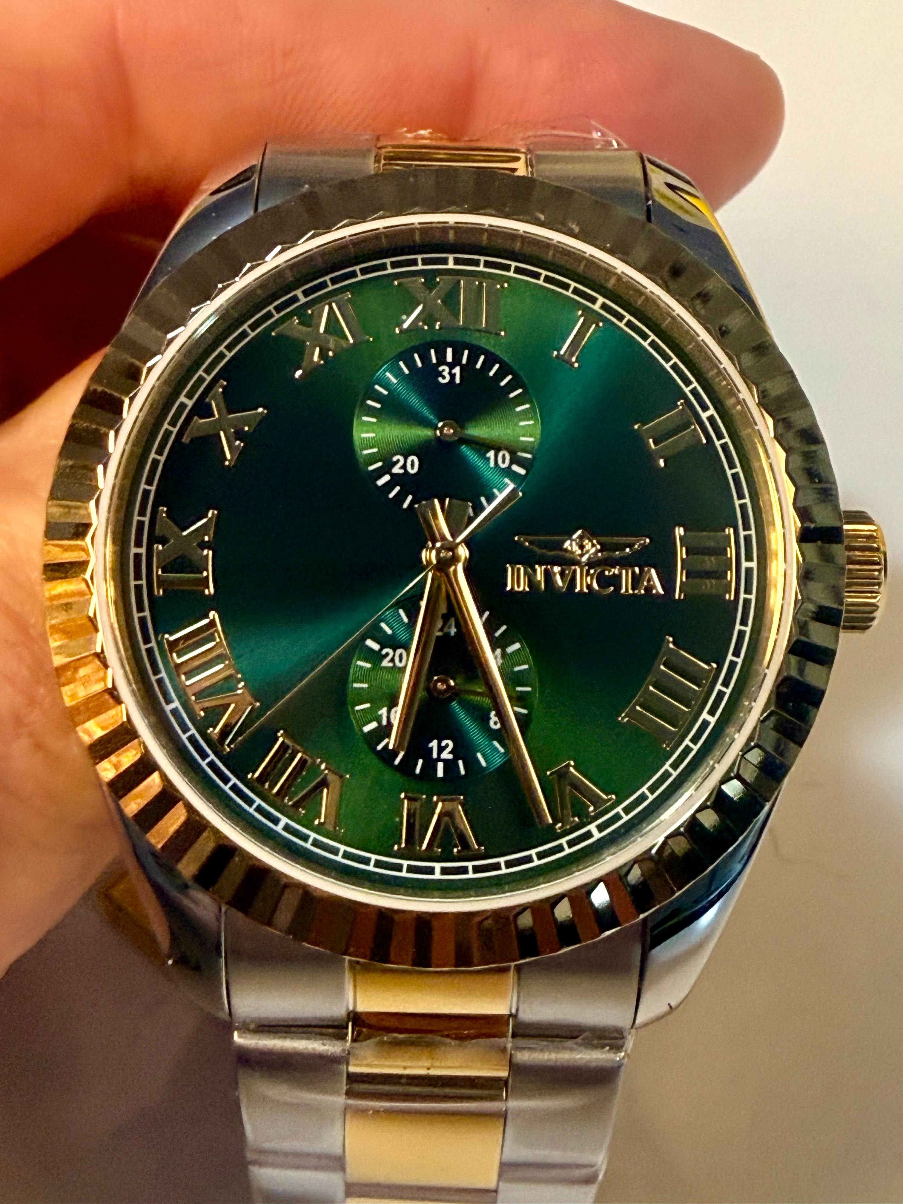 Invicta Mens Specialty Belmont 43mm Luxury watch with green face and gold accents held by a hand