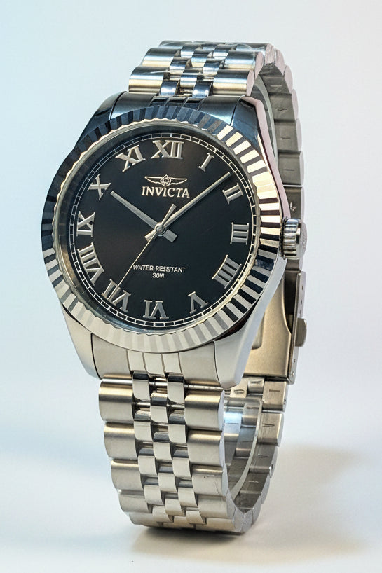 Mens Specialty Rowan 43mm Silver Invicta watch with black face on a white surface